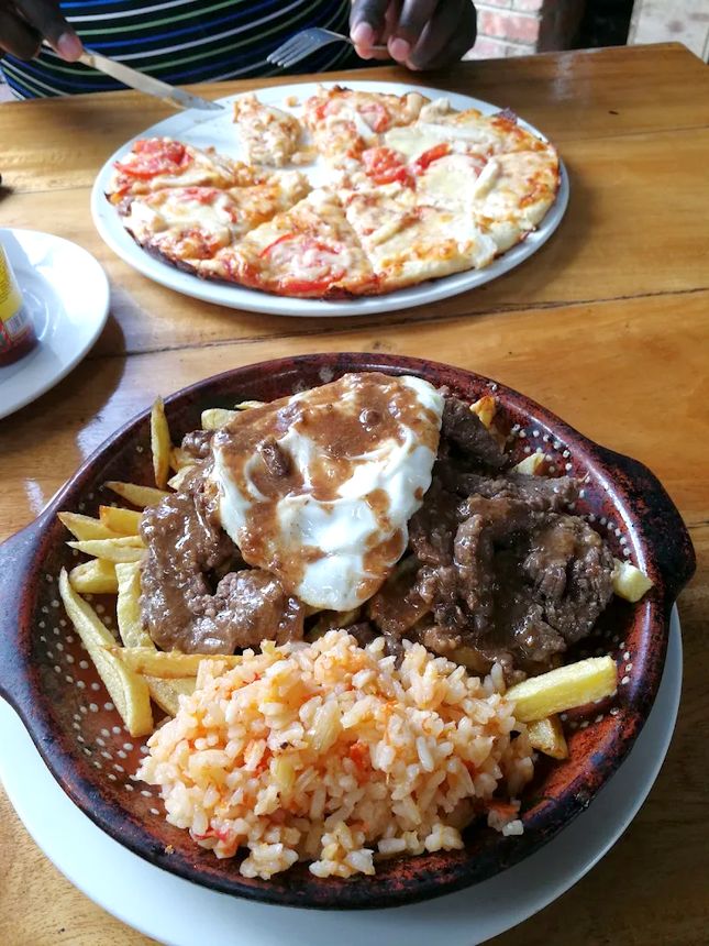 Portuguese beef bitoque with fried egg, chips and tomato rice