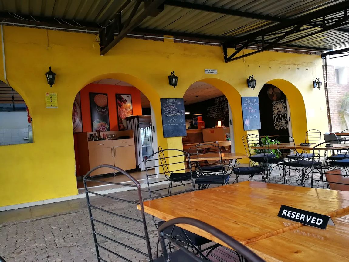 The yellow-arched courtyard by day, with chalkboard menus